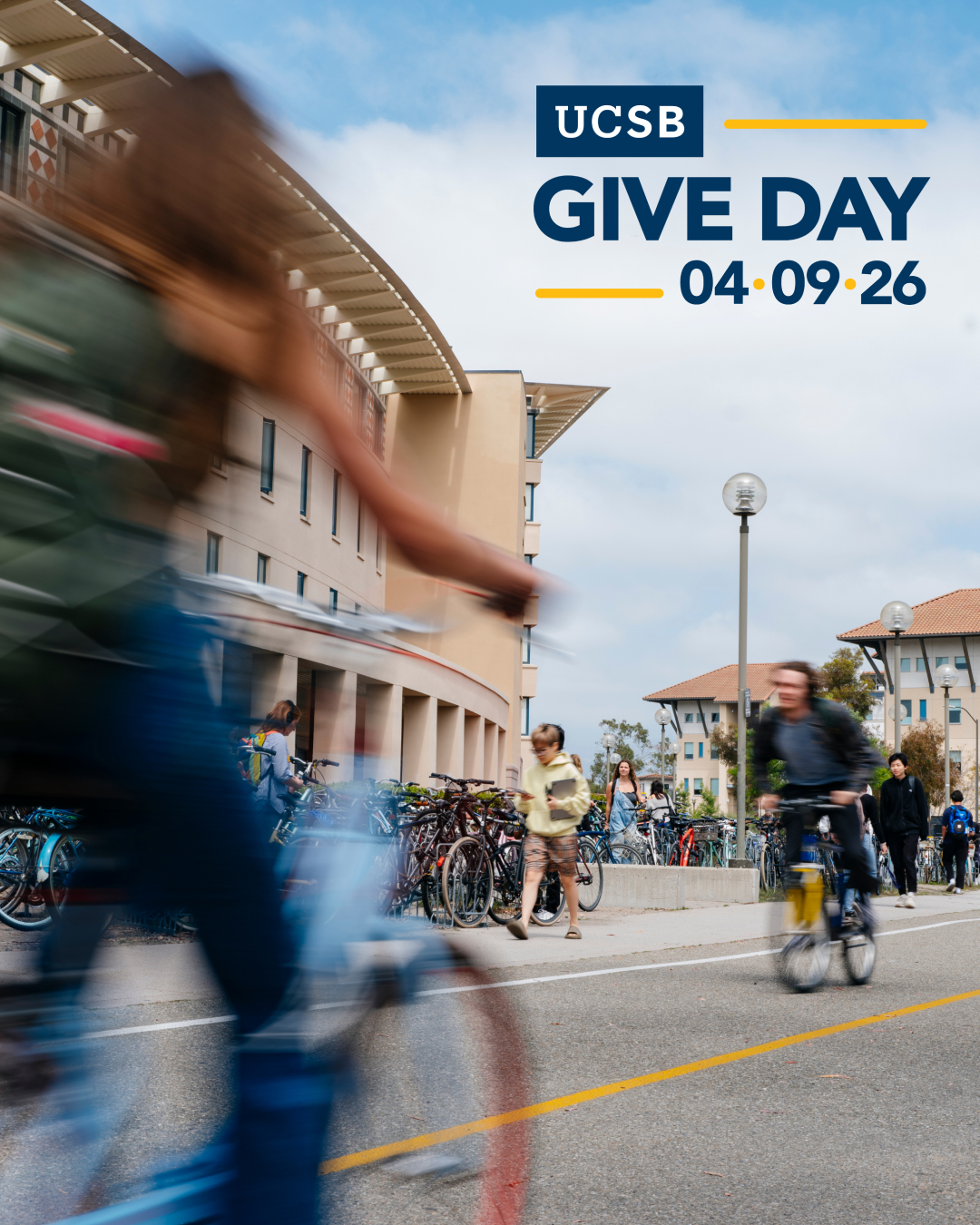 Photo of bicycle speeding across ucsb campus with give day logo